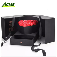 Vente en gros de boîte cadeau de fleurs rondes en carton cylindrique noir de luxe personnalisée pour fleurs avec traitement d'impression de gaufrage