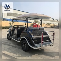 Voiturette de golf électrique noire et champagne au style vintage pour le transport dans les complexes hôteliers et l'hôtellerie