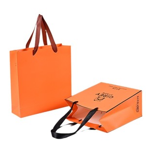 Bolsas de Regalo de Papel de Lujo Color Naranja con Logotipo Personalizado y Asa de Listón - Product Image 1