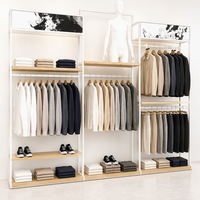 Présentoir îlot double barre en métal noir pour vêtements avec étagères latérales à chaussures et base en bois – Vente en gros