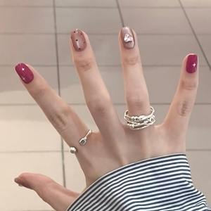 Lot de 10 faux ongles en acrylique pré-dessinés, forme amande, avec motifs œil de chat rose nude, étoiles, cœurs, pois et cristaux noirs - Product Image 2