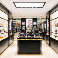 Présentoir à parfums noir et or en verre, comptoir îlot, étagères murales, boîte à lumière, affiche CE ETL pour magasin de beauté