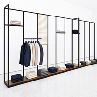 Porte-vêtements mural linéaire fin en métal noir avec accent grille dorée et base en bois – Fabricant