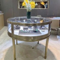 Présentoir de bijoux en or et diamant moderne de luxe Table ronde en acier inoxydable pour vitrine avec lumière LED