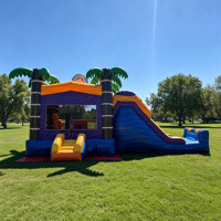 Château gonflable commercial sur le thème de l'océan avec toboggan et palmiers pour la location de fêtes d'enfants