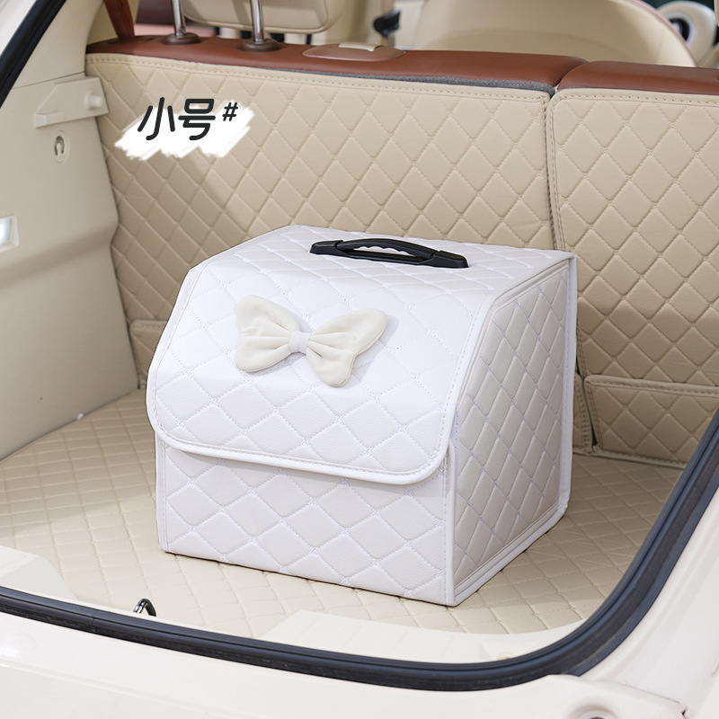 Petite boîte de rangement pliante, blanche avec noeud en velours blanc.