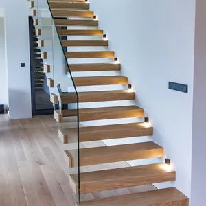 Escaleras flotantes en voladizo de diseño elegante con larguero invisible de acero al carbono, escalones de mármol de madera maciza con barandillas de vidrio