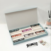 Boîte de présentation haut de gamme en cuir pour lunettes et lunettes de soleil, 12 compartiments, avec fermeture magnétique, design multi-grilles, grande capacité de rangement
