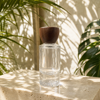 Flacon de parfum de luxe personnalisé en verre cylindrique haut de gamme avec base lourde et bouchon en bois, vente en gros d'usine