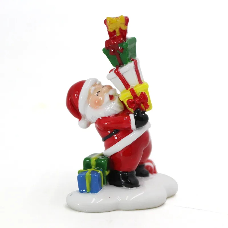 Papai Noel segurando a estátua da resina do presente para a decoração do Natal
