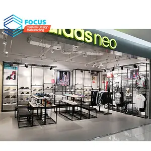 Toptan spor salonu mobilya paslanmaz çelik kumaş Showroom iç tasarım ekran raflar ve giysiler için duruyor