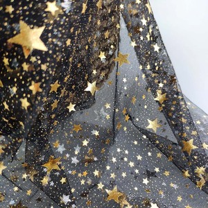 Black tulle with gold foil star design polyester mesh fabric