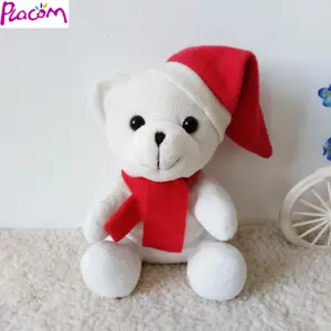 圣诞礼物毛绒毛绒白熊与红帽子和围巾