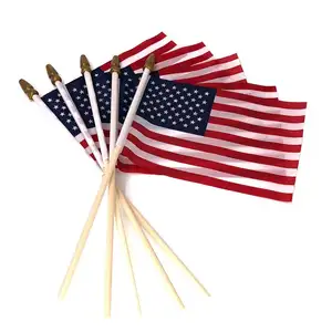 木製の棒で旗を振るアメリカ国旗