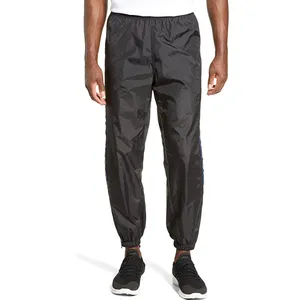 Pantalones de chándal personalizados para hombre, 100% nailon, con cremallera, elásticos, rompevientos