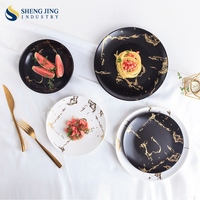 Shengjing assiette de luxe ronde noire en porcelaine émaillée de couleur blanche vaisselle en porcelaine assiette à dîner en céramique pour restaurant hôtel
