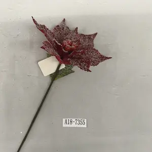 snowy red poinsettia flower with red berry stamen