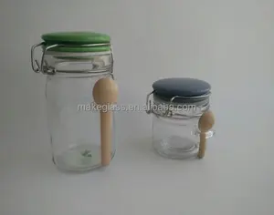 glass jar with lid and wood small spoon , glass jar with ceramic lid