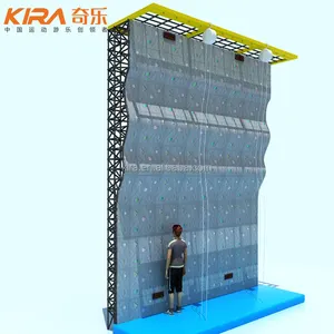 Commercial indoor climbing wall with colorful climbing holds and climbing harness