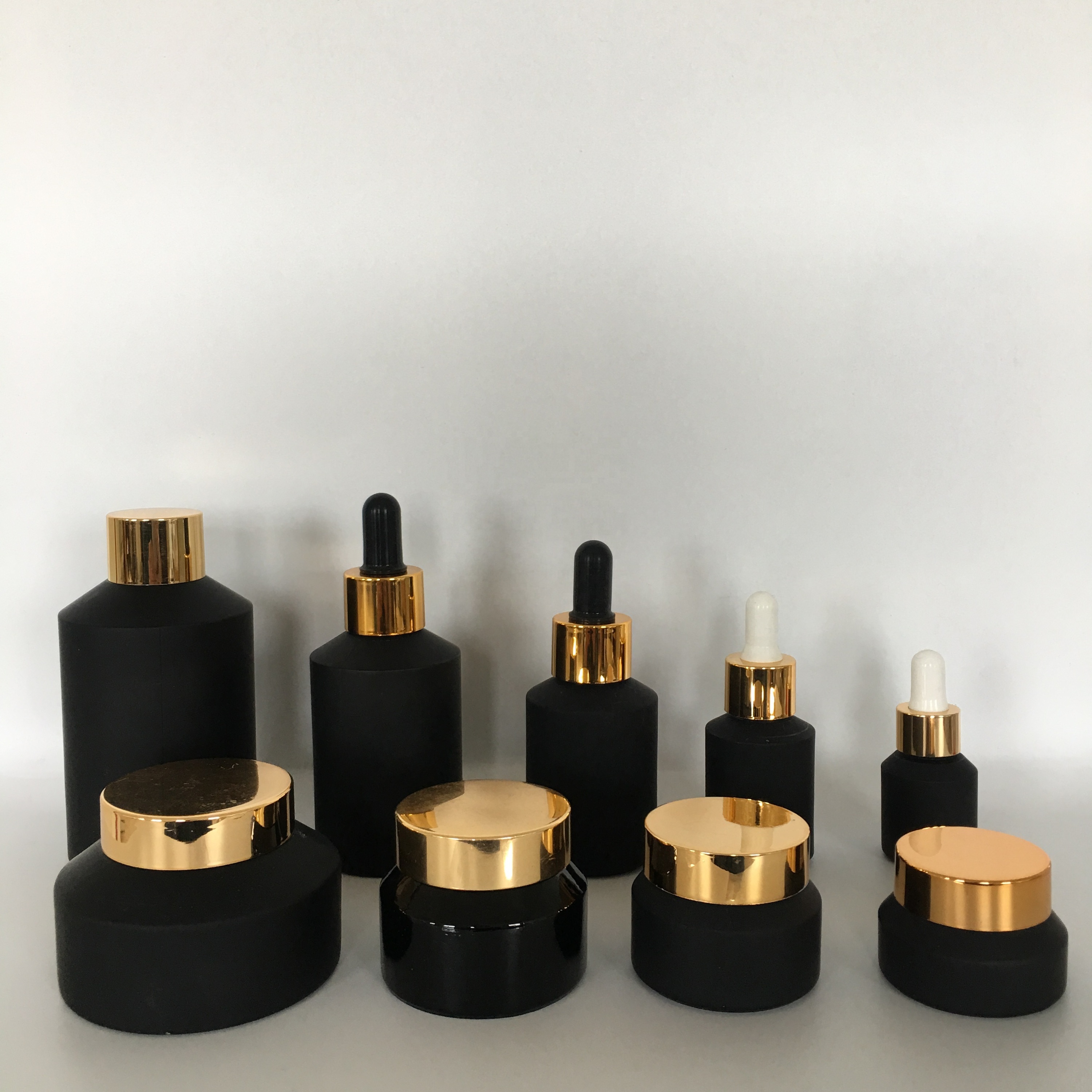 Factory hot sale cosmetic bottle jar packaging series frosted black slant shoulder glass lotion bottle with gold lid