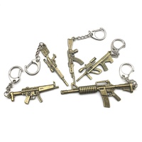 Vente en gros de porte-clés arme de feu croisé en acier inoxydable et en alliage de zinc pour hommes, bijoux artisanaux en métal, pendentifs, logo laser de style dessin animé