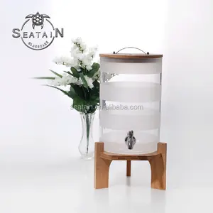 clear round glass soft drinking dispenser with tap wooden stand