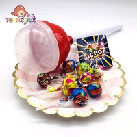 Super gros bonbon à sucette intéressant et propre avec un jouet fruité dur rempli de sucre enrobé dans une bouteille