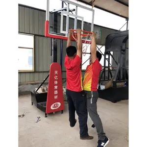 Team trains full size manual hydraulic basketball stand