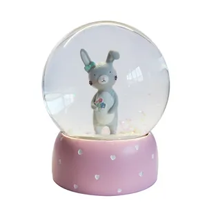 Bola de nieve con base rosa, caja de música, cristal, conejo de dibujos animados, globo de nieve, 100mm