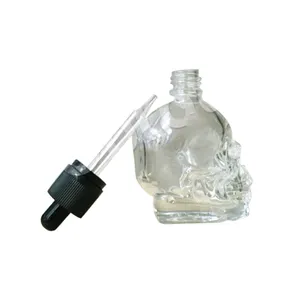 China Supplier skull dropper bottle,unique shaped clear glass bottles skull for liquid essential oils