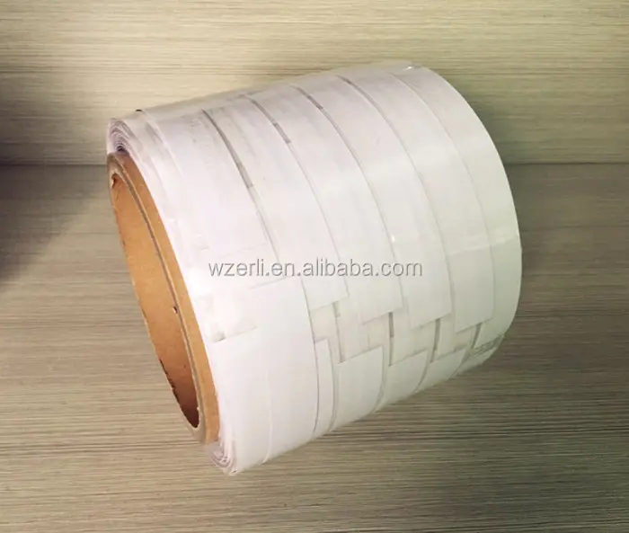 spooled adhesive handle tape with white paper label applied by the handle applicator