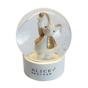 Cute rabbit golden cloth snow globe custom made white base animal snow ball