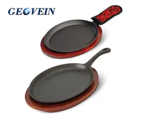 Oval cast iron fajita skillet with wooden base