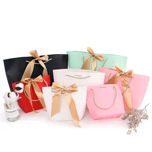 Factory direct supply creative custom bow shopping bag cosmetics big red clothing paper bags