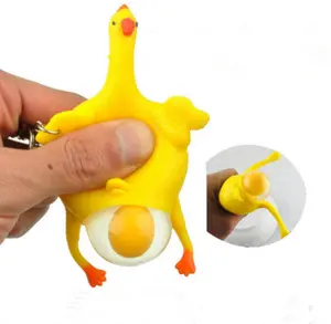 Hot selling creative trick-playing toy yellow rubber chicken lays eggs toy, plastic keychain toy