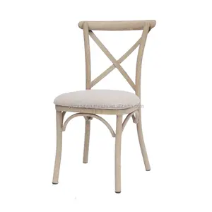 Aluminum cross back chair with padded seat in wooden color finish