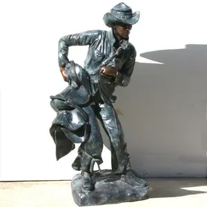 Western Life Metal Craft Cast Bronze Cowboy Holding Saddle Statue