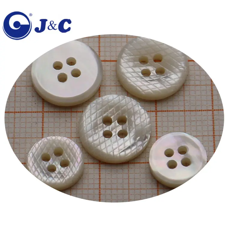 white and black mother of pearl shell buttons with netting decorative pattern