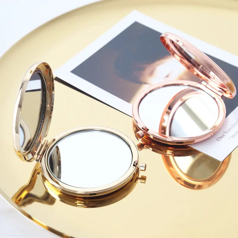 Venta al por mayor pequeño vintage metal mano redonda lujo pliegue oro acrílico compacto espejo