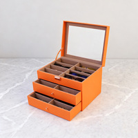 Caja expositora de gafas de cuero PU naranja, negro y verde con 24 ranuras y 2 cajones, nueva, al por mayor