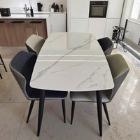 Ensemble table et chaises de salle à manger de luxe italien, moderne et simple, pour petit appartement urbain, avec plateau rectangulaire en pierre de type ventre de cheval.