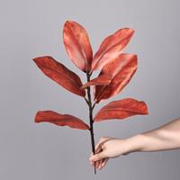 Vente en gros d'usine : Branche unique de fausses feuilles de magnolia pour la décoration de vases dans les intérieurs résidentiels, les hôtels et les salles d'exposition