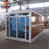 Maison pliable en bois grainé Cbox avec porte coulissante en verre, maison préfabriquée modulaire en conteneur pliable