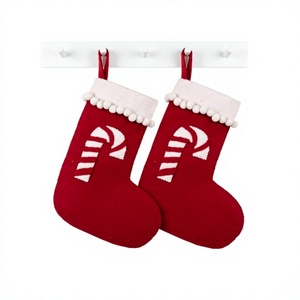 Chaussettes de Noël artisanales en feutre de laine rouge écologiques avec imprimé canne à sucre et bordure pompon, décoration murale - Product Image 1