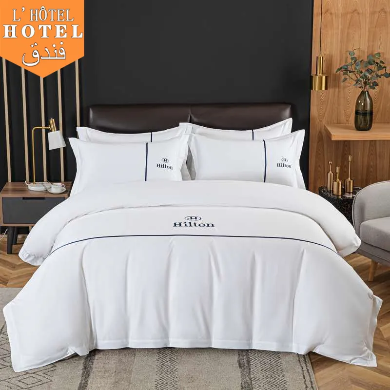 Juego de sábanas de algodón con logotipo bordado para Hotel, juego de ropa de cama con logotipo personalizado, color blanco