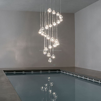 Lustre moderne à pampilles multiples en verre galet irrégulier pour escalier, salle à manger d'hôtel, hall d'entrée et éclairage de projet