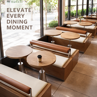 Banc de café avec coussin crème et traversin marron, table en marbre avec piédestal doré, chaises et tables pour restaurant ou café