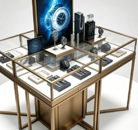 Comptoir de présentation de bijoux et montres multi-compartiments sur mesure, vitrine îlot en verre doré brossé avec tiroirs de rangement et éclairage LED