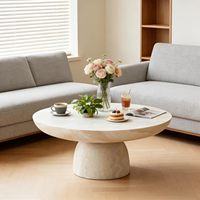 Table basse ronde contemporaine sur piétement avec finition en pierre naturelle