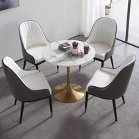 Ensemble de chaises de salle à manger en métal de style moderne avec table ronde en marbre mobilier durable pour petits cafés et restaurants